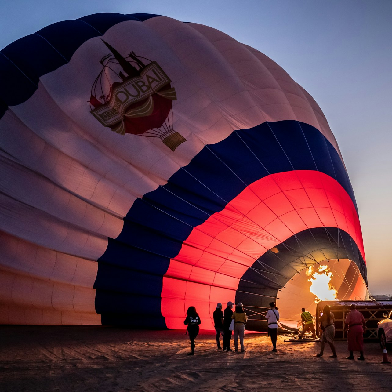 Soar above the stunning Dubai desert at sunrise witnessing the endless sands and unique landscapes from a hot air balloon providing unforgettable photo opportunities and a unique perspective.